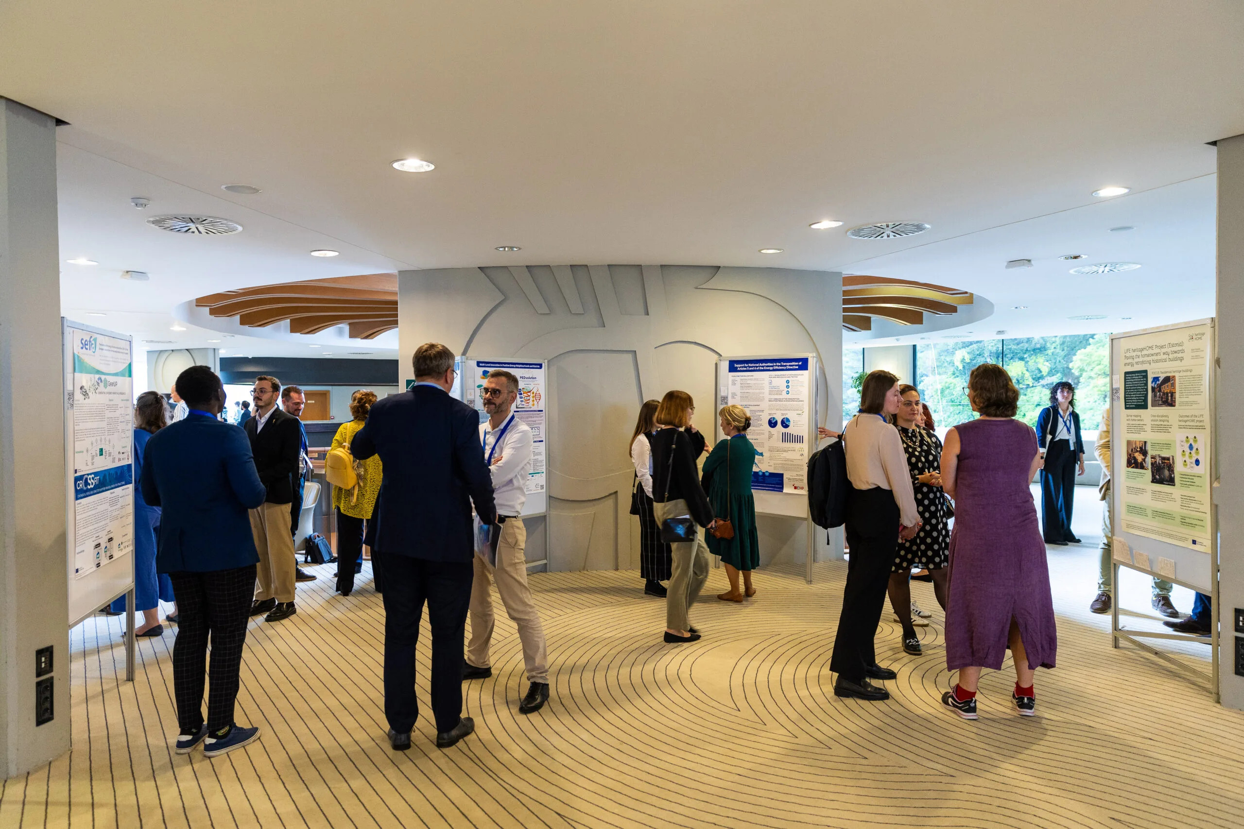 Poster authors and participants in conversation during the C4E Forum 2025 Knowledge Hub poster session